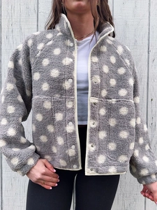Close-up of gray polka dot fleece jacket with metal buttons and high neck texture