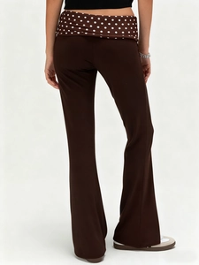 Women's dark brown flare pants with polka dot waistband detail in a slim fit style