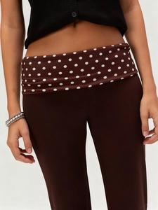 Women's dark brown slim fit trousers featuring a stylish polka dot fold-over waistband