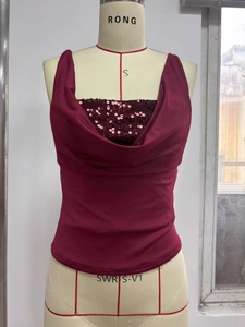 Macro detail of the elegant burgundy cowl neck top featuring shimmering sequin trim embellishments