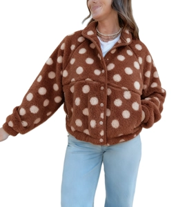 Detail of plush brown fleece jacket with white polka dots, button closure and large pockets