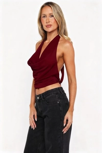 Close-up of burgundy cowl neck halter top with backless design and satin texture