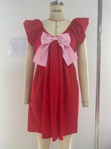 Detail of red V-neck party dress with large pink bow on a professional mannequin