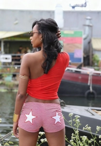 Detail view of pink striped shorts with white star print and high waist slim fit design