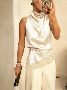 Elegant sleeveless satin halter top and wide-leg trousers with lace patchwork detail