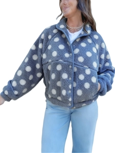 Detail of blue polka dot fleece jacket featuring a high collar and grey buttons