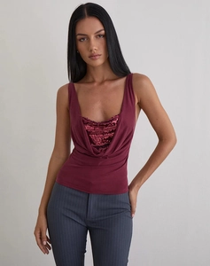 Detail of burgundy sequin neckline on a sleeveless U-neck top with pleated drape texture