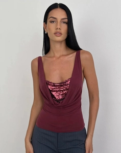 Detailed view of the sparkling burgundy sequin top with a stylish V-neck drape design