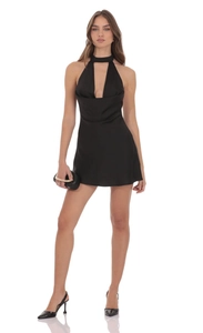 Détail d'une mini robe dos nu en satin noir avec col bénitier élégant et découpes chic