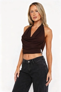 Detail of the draped cowl neck and lightweight chiffon fabric on a brown halter top