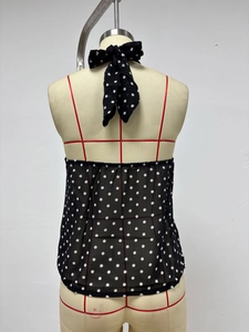 Detail view of polka dot halter top showing back tie closure and elastic band