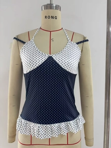 Detail of contrast polka dot patchwork on backless halter top with ruffled hem
