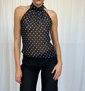 Detailed macro shot of the sheer polka dot fabric and halter neckline texture