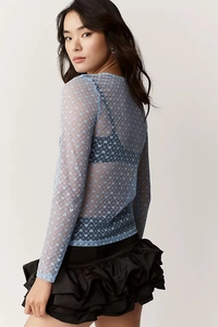 Detailed view of light blue mesh top showing semi-transparent heart pattern texture