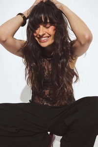 Close-up of intricate black floral lace pattern on a backless halter neck top for women