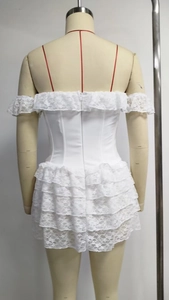 Detailed back view of a white lace corset dress with ruffled layered hem and off-shoulder design