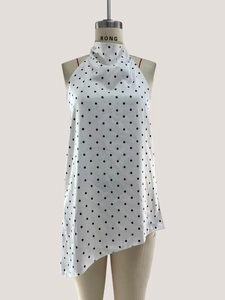 Detailed view of polka dot halter top with high scarf neckline and asymmetric hem