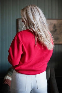 Rear view of a loose-fitting red crew neck sweatshirt with drop shoulders for women