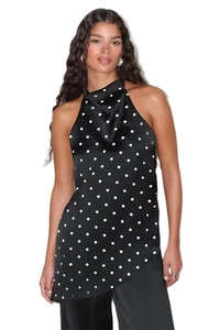 Detailed view of black and white polka dot halter top with pleated neckline and silk finish
