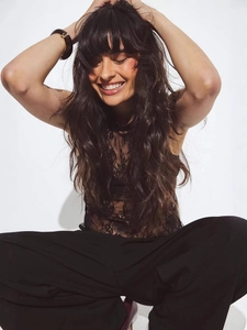 Chic black lace halter top with open back paired with high waist trousers for women