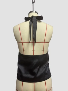 Detailed back view of a black satin halter top featuring an elegant bow tie and open back design