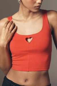 Close-up of a red ribbed tank top featuring a unique heart-shaped cutout on the chest area
