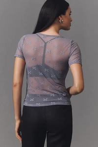 Vue arrière détaillée d'un haut en tulle transparent avec pois en velours et motifs nœuds