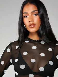Detailed texture of semi-transparent black mesh top with white polka dot patterns