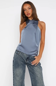Detail of blue satin halter top showing luxurious silk texture and crossover neck design