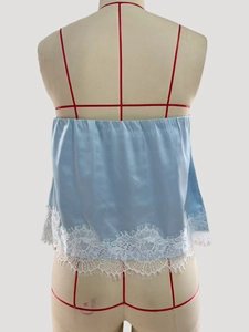 Detailed back view of a light blue satin camisole top with elegant white lace hem