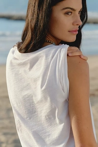 Gros plan sur le t-shirt blanc en tissu texturé respirant sur une plage ensoleillée