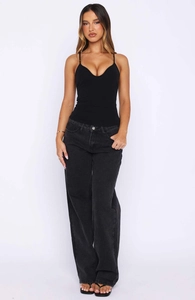 Detailed view of women's black V-neck camisole with ruching and high waist wide leg jeans