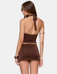 Detail of the back tie-up halter neck and slim fit tailoring of the brown two-piece set