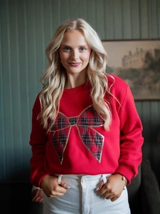Women's red crewneck sweatshirt with a large plaid bow graphic and golden sequins