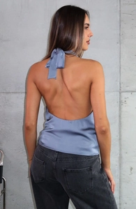 Detail of grey-blue satin halter top showing backless design and bow-tie neckline