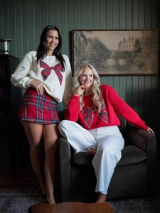 Women's crewneck sweatshirts with large plaid bows and sequin trim for holiday style
