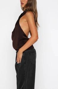 Detail of dark brown satin halter top featuring a backless cut and silky smooth texture