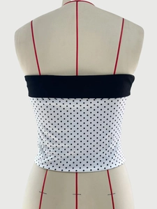 Detail of black and white polka dot tube top showing back design and elastic texture
