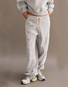 Close-up of light grey joggers featuring star patchwork and thick cotton drawstring waist