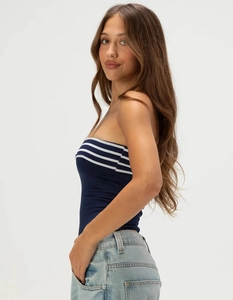 Side view of a slim fit navy blue striped knit tube top paired with light blue jeans