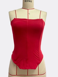 Close-up of bright red strapless bandage top with lace-up waist detail on mannequin
