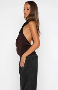 Detailed view of backless chocolate satin halter top with silky texture and draped fit