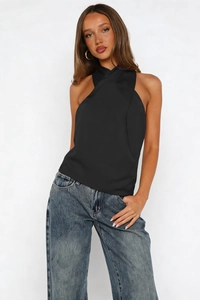 Detail of elegant black satin halter neck top with smooth silk texture and clean tailoring