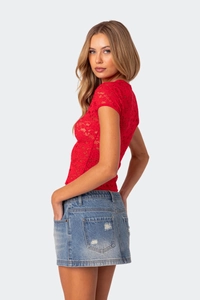Close-up of red floral lace fabric texture on a slim-fit summer crop top for women
