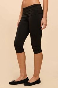 Detail shot of black high-waisted capri leggings with premium elastic slimming fabric