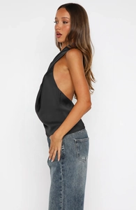 Detail of the backless halter neck design on a sleek black satin sleeveless blouse