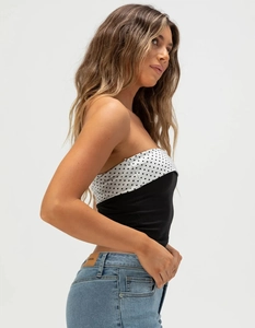 Close-up of slim-fit backless tube top with polka dot pattern and sleek two-tone design