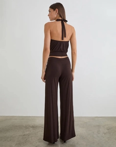 Back view of a deep brown halter neck crop top and matching wide leg high-waist trousers