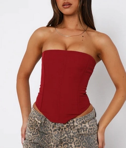 Detail of burgundy corset top with structural seams and strapless tube neckline