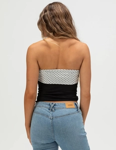 Detail of slim fit backless tube top featuring polka dot pattern and black panel contrast